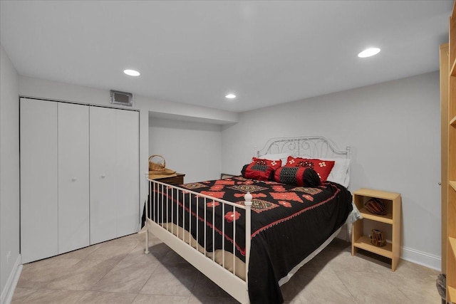 bedroom featuring light tile patterned floors and a closet