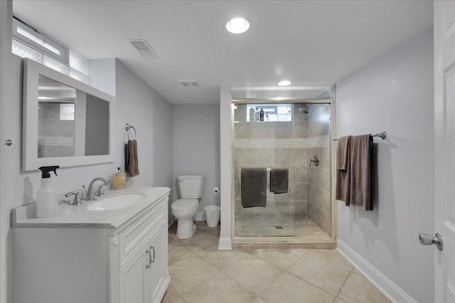 bathroom featuring tile patterned flooring, vanity, toilet, and a shower with shower door