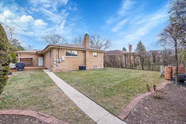 exterior space featuring a lawn and central AC unit