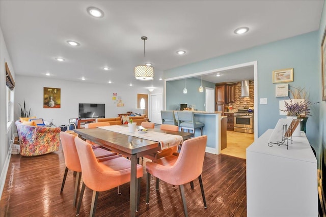 dining space with hardwood / wood-style floors