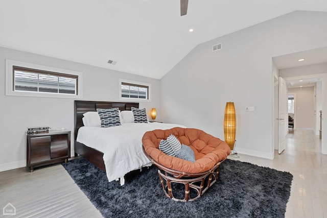 bedroom with high vaulted ceiling, ceiling fan, and light wood-type flooring