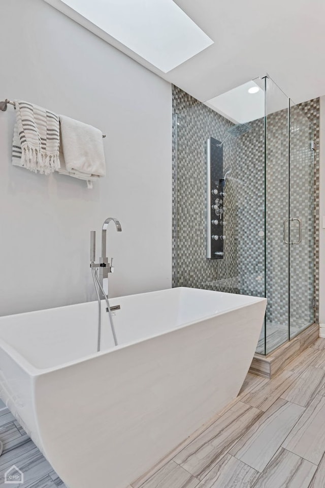 bathroom with plus walk in shower and a skylight