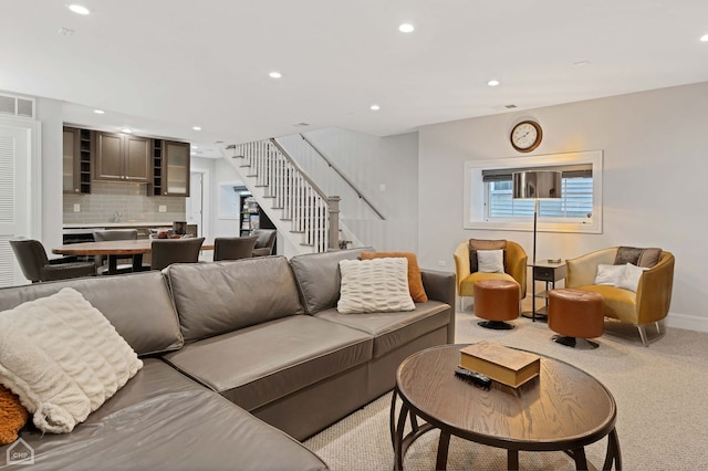 carpeted living room with sink