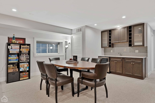 carpeted dining room featuring beverage cooler