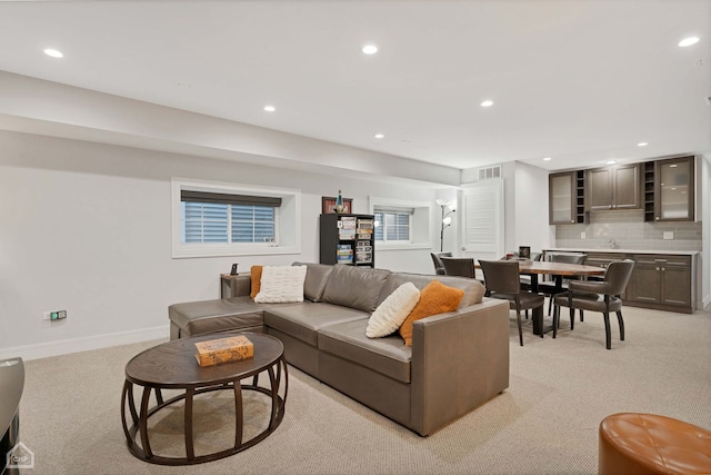 living room featuring sink and light colored carpet