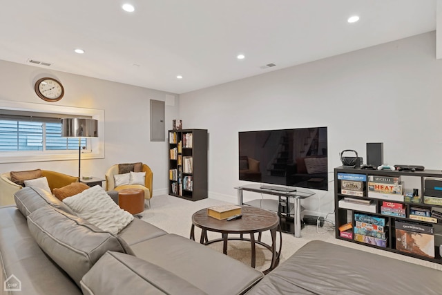 living room featuring light colored carpet and electric panel