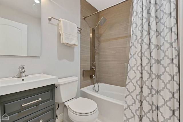 full bathroom with vanity, shower / tub combo with curtain, and toilet