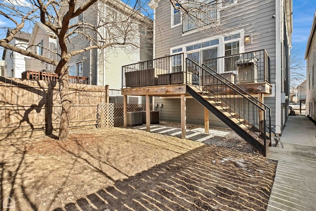 rear view of property featuring a deck and central air condition unit