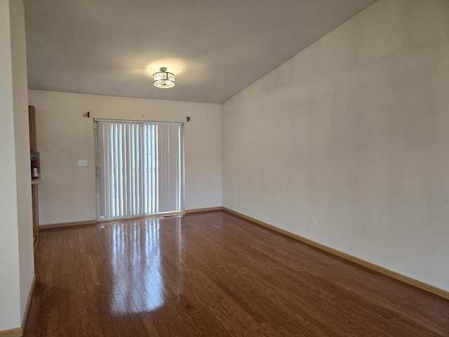 unfurnished room with wood-type flooring