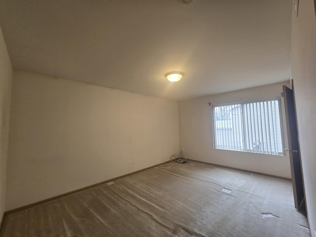 unfurnished room featuring light colored carpet