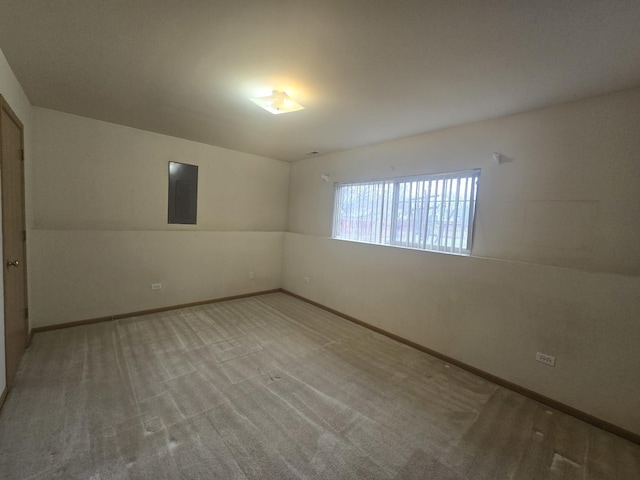 empty room with carpet, electric panel, and lofted ceiling