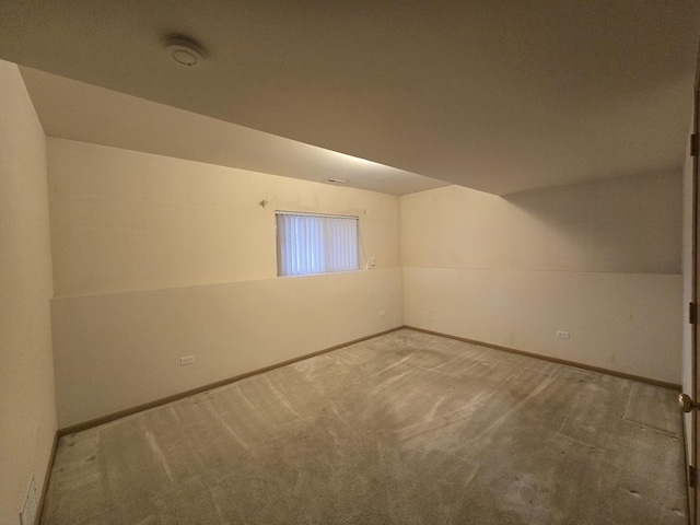 interior space with carpet and vaulted ceiling