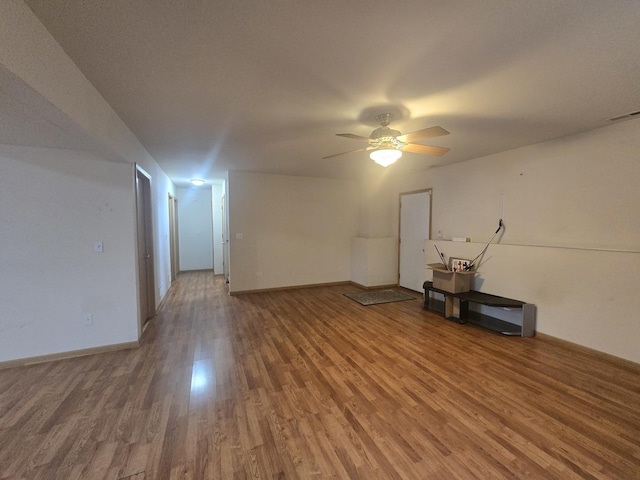 empty room with ceiling fan and wood-type flooring