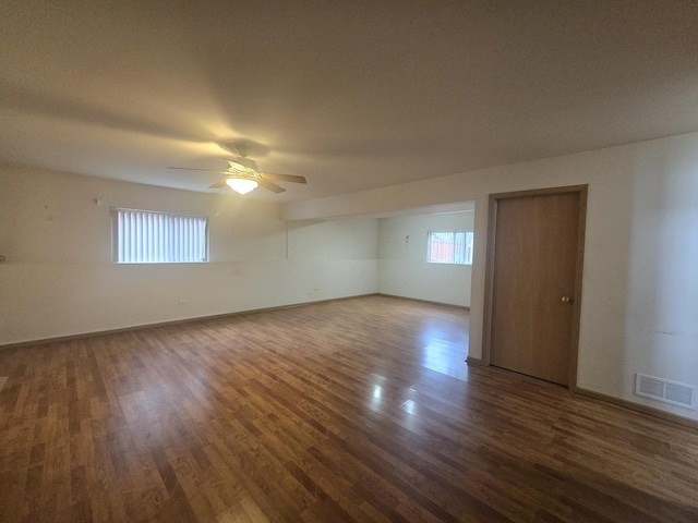 empty room featuring ceiling fan and dark wood-type flooring