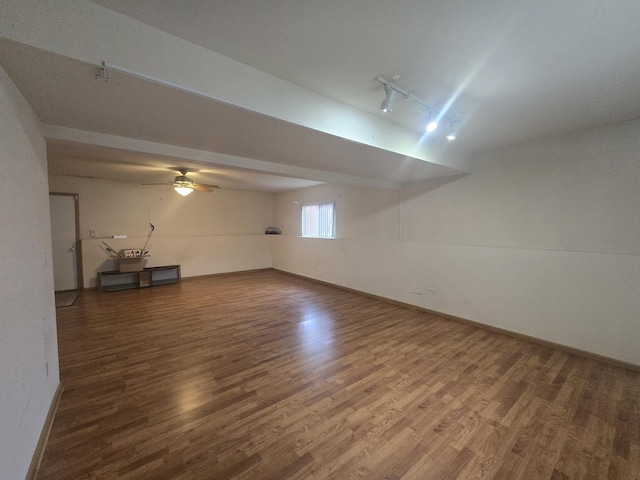 interior space with track lighting and hardwood / wood-style flooring