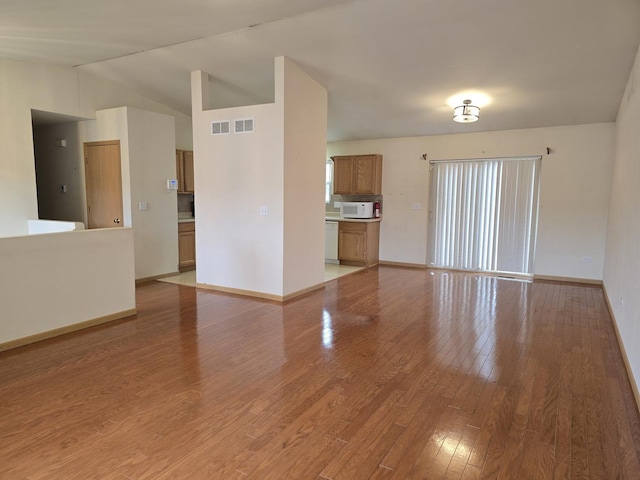 unfurnished living room with light hardwood / wood-style flooring and vaulted ceiling