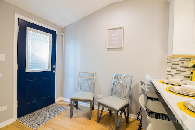 entryway featuring light hardwood / wood-style flooring and vaulted ceiling