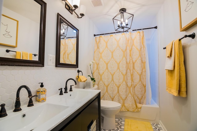 full bathroom with an inviting chandelier, backsplash, toilet, shower / bath combo with shower curtain, and vanity