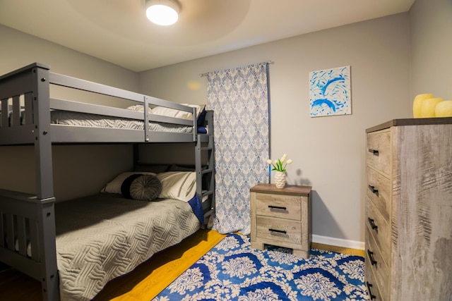 bedroom with ceiling fan and hardwood / wood-style flooring