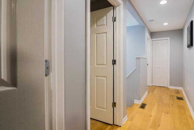 hallway with light hardwood / wood-style flooring