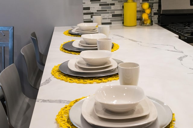 room details with light stone countertops, tasteful backsplash, and black range with gas cooktop