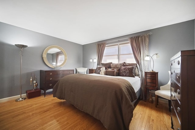 bedroom with baseboards and wood finished floors