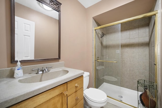 bathroom with toilet, a stall shower, and vanity