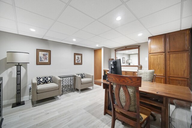 bedroom with light tile patterned floors and a drop ceiling