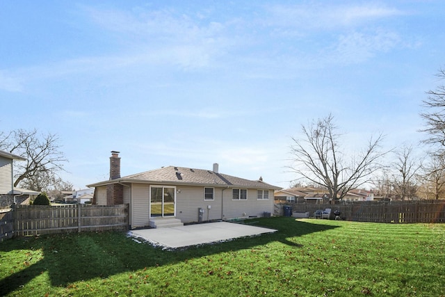 rear view of property with a chimney, a lawn, entry steps, a patio area, and a fenced backyard