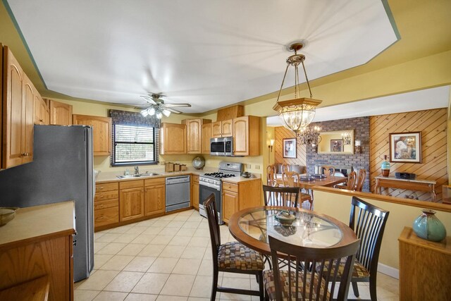 kitchen featuring ceiling fan with notable chandelier, white appliances, and sink