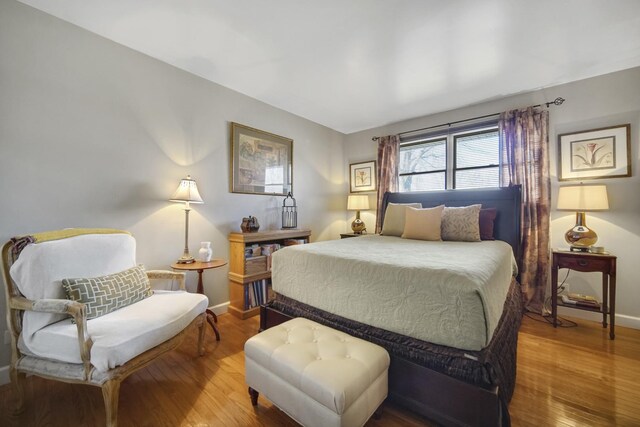 bedroom with hardwood / wood-style flooring, ornamental molding, and coffered ceiling