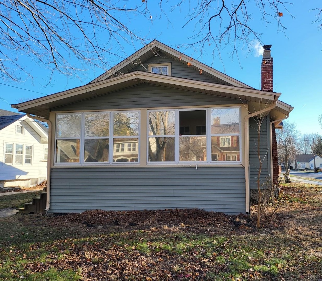 view of side of property featuring a sunroom