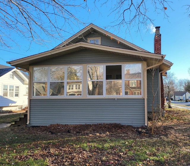 view of side of property featuring a sunroom