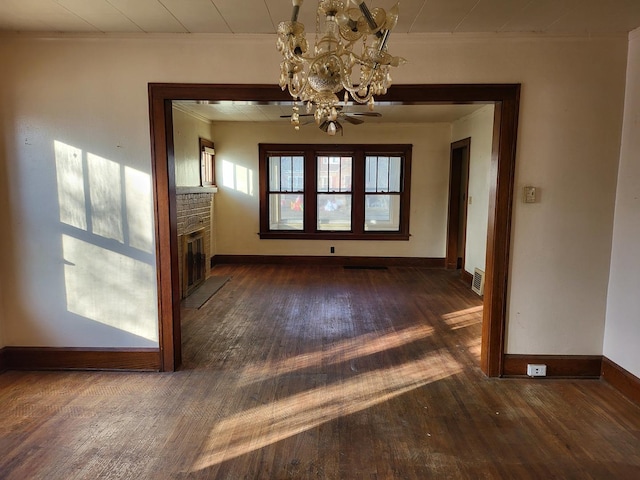 interior space featuring a fireplace, dark wood-type flooring, and a chandelier