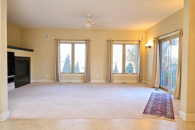 unfurnished living room with light carpet and ceiling fan