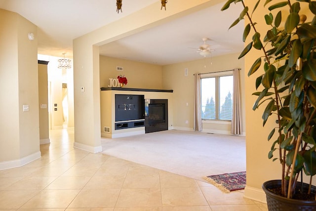 carpeted living room featuring ceiling fan with notable chandelier