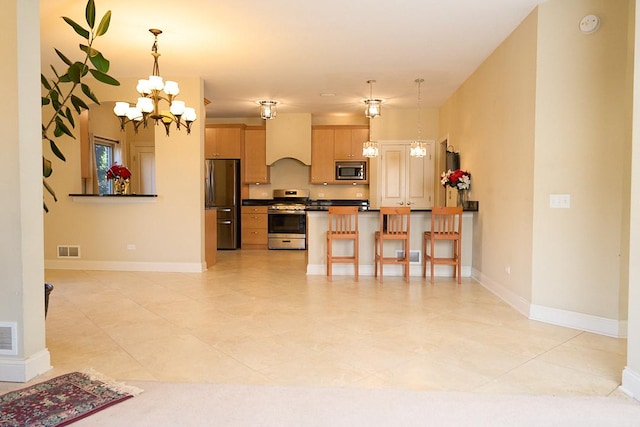 kitchen with light brown cabinets, an inviting chandelier, hanging light fixtures, custom range hood, and stainless steel appliances