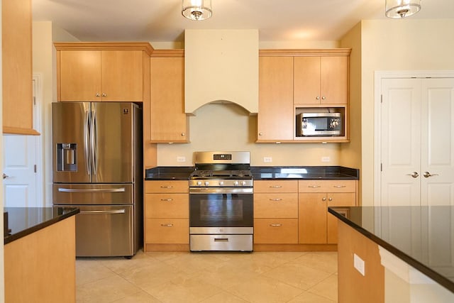 kitchen featuring light brown cabinets, light tile patterned flooring, custom range hood, and appliances with stainless steel finishes