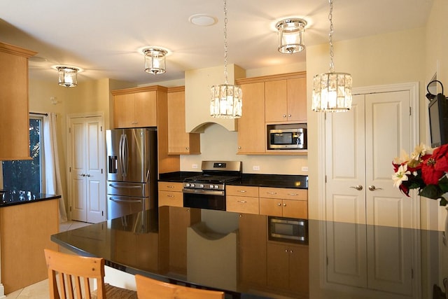 kitchen with pendant lighting, light brown cabinets, and stainless steel appliances