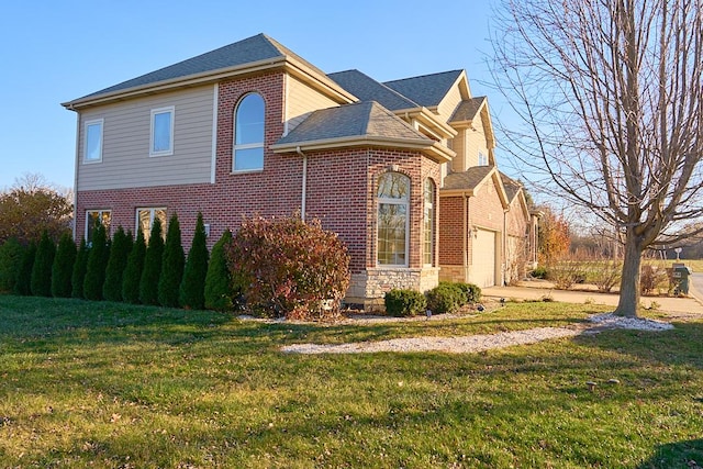 view of front of property with a garage and a front lawn