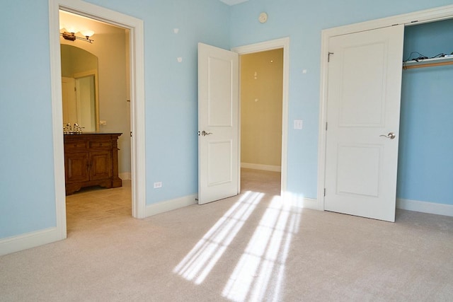 unfurnished bedroom featuring light carpet, connected bathroom, and a closet