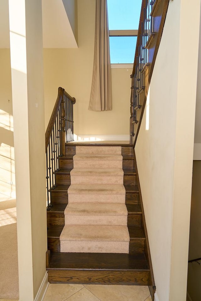 stairway with tile patterned floors