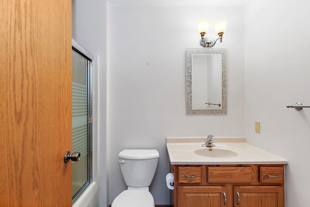 full bathroom featuring shower / bath combination with glass door, vanity, and toilet