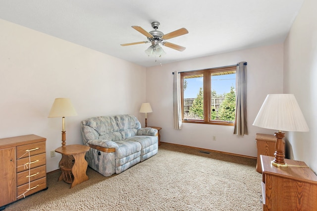 sitting room featuring carpet and ceiling fan