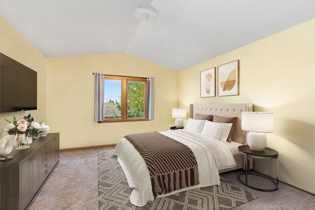 bedroom featuring light colored carpet and vaulted ceiling