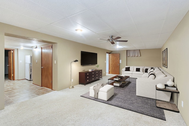 carpeted living room featuring a paneled ceiling and ceiling fan