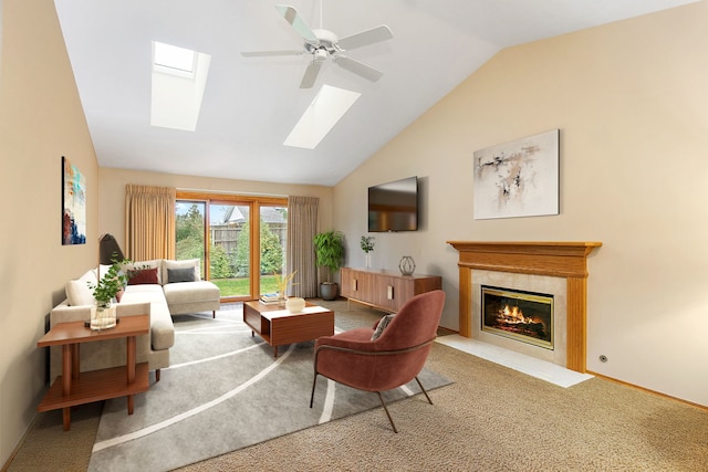 carpeted living room with a tile fireplace, ceiling fan, and lofted ceiling