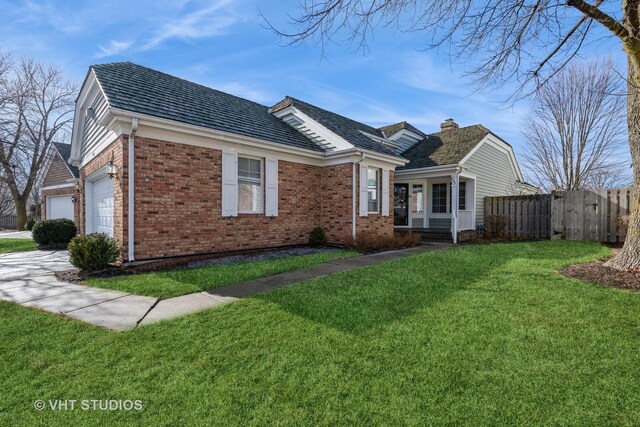 view of front of home with a garage and a front lawn