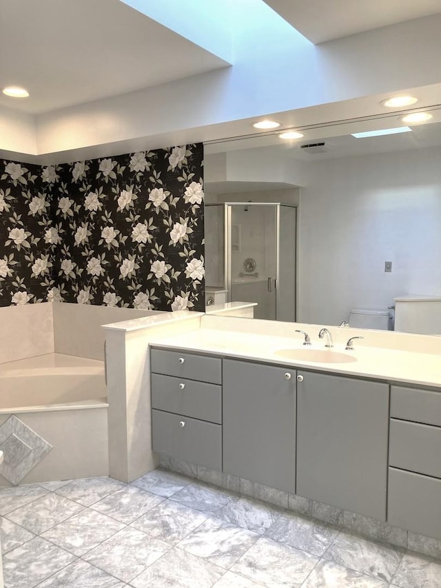 bathroom with independent shower and bath and vanity