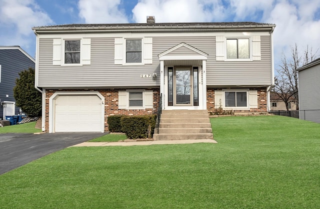 raised ranch with a front yard and a garage